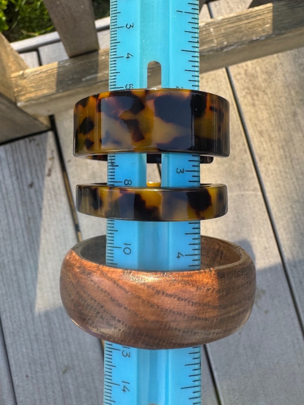 Lot of three Bracelets:  two faux tortoiseshell cuffs and one wood bangle